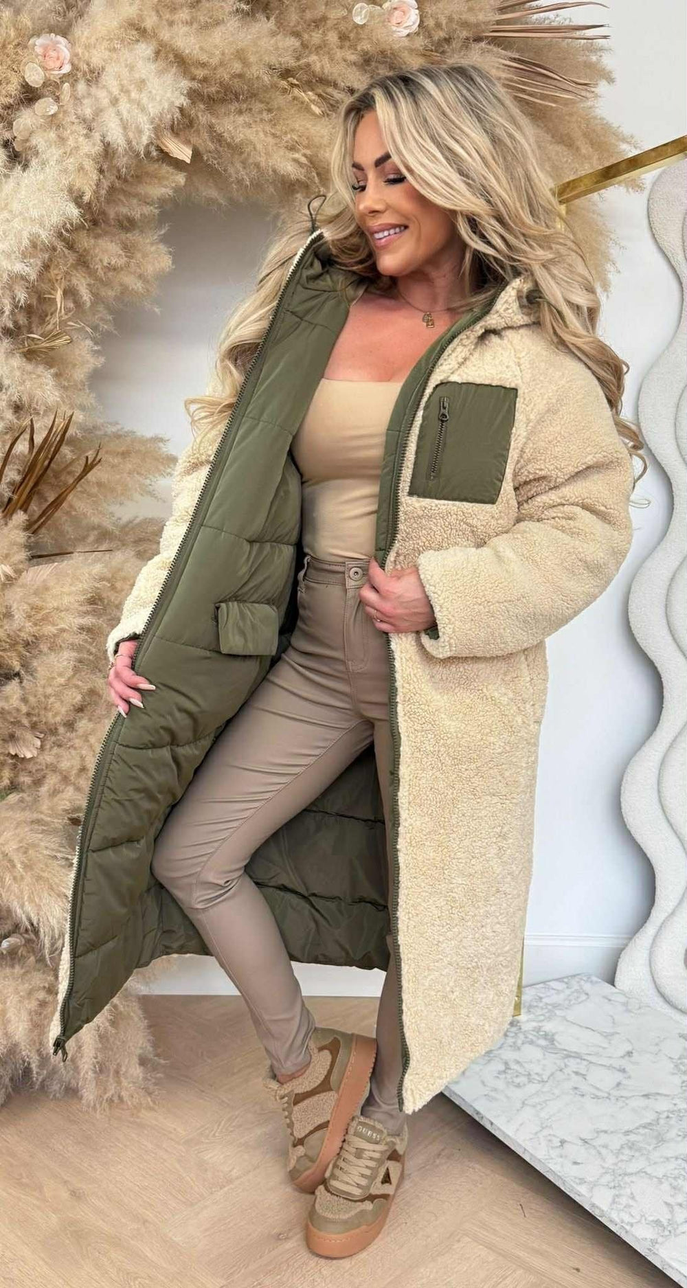 Blueberry reversible long quilted winter coat in green featuring its plush lining side.